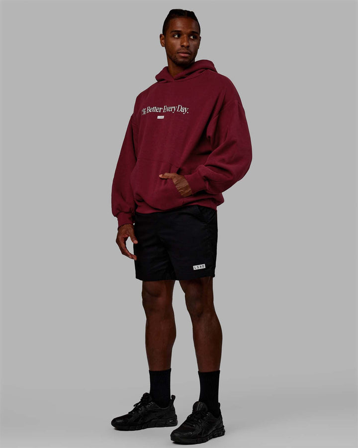 Man wearing Unisex 1% Better Hoodie Oversize - Cranberry-White