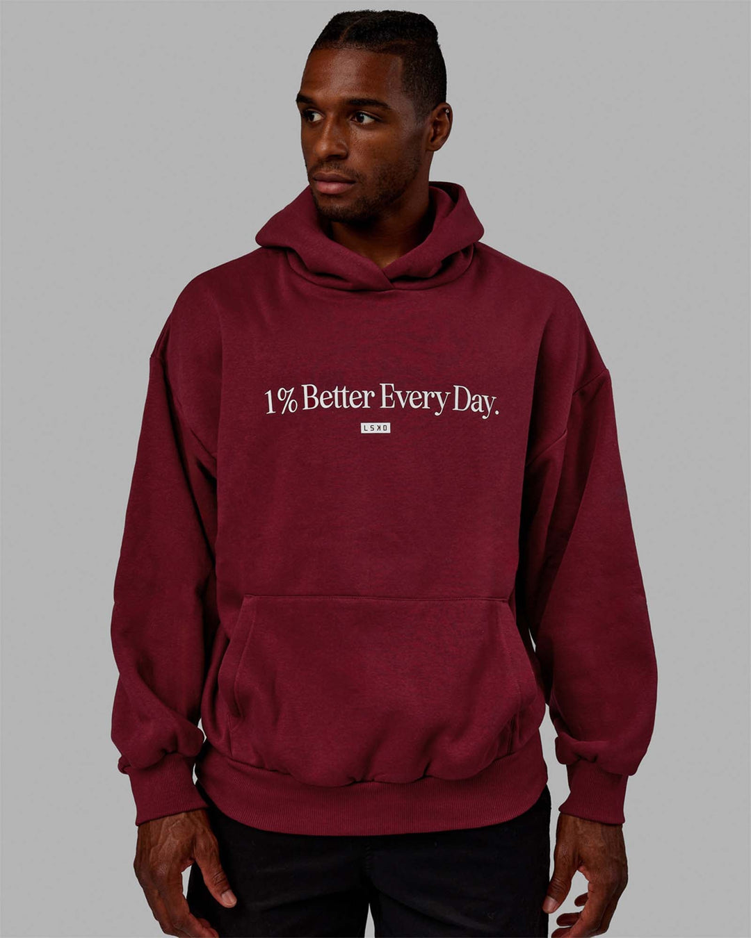 Man wearing Unisex 1% Better Hoodie Oversize - Cranberry-White