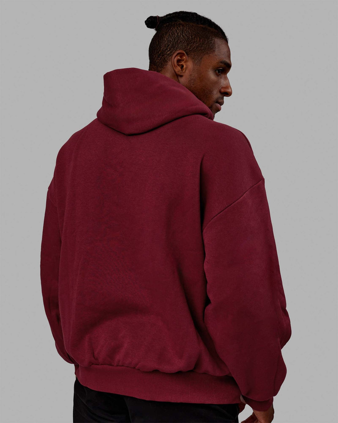 Man wearing Unisex 1% Better Hoodie Oversize - Cranberry-White