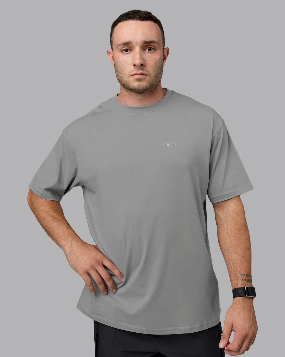 Man wearing Unisex 1% Better Value Series FLXCotton Tee Oversize - Circular Grey-White