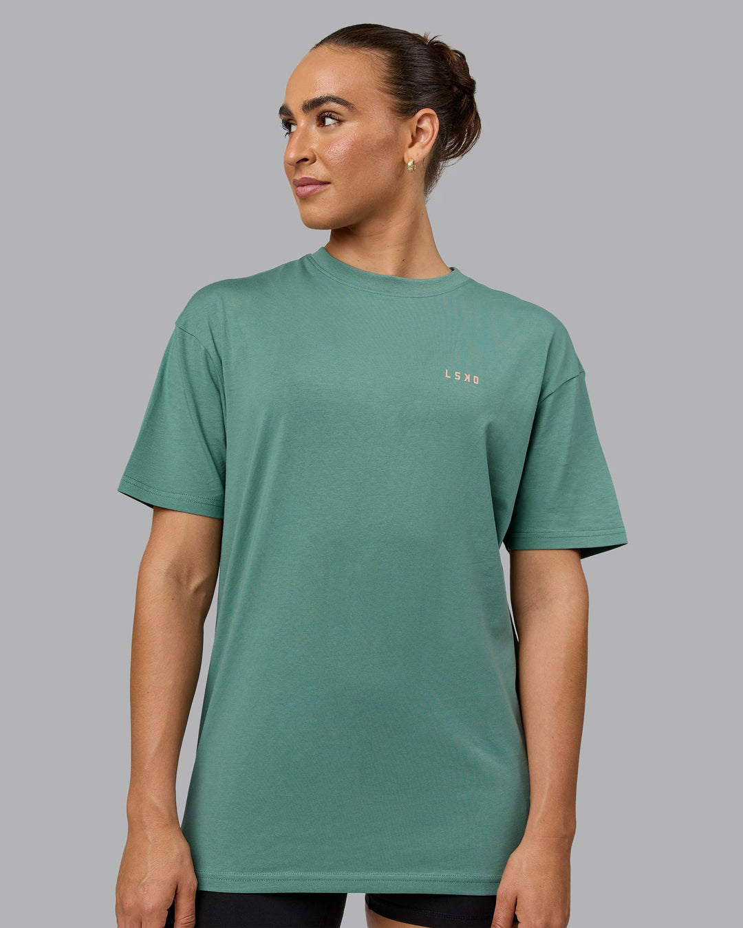 Woman wearing Unisex 1% Better Value Series FLXCotton Tee Oversize - Sagebrush-Mellow Peach