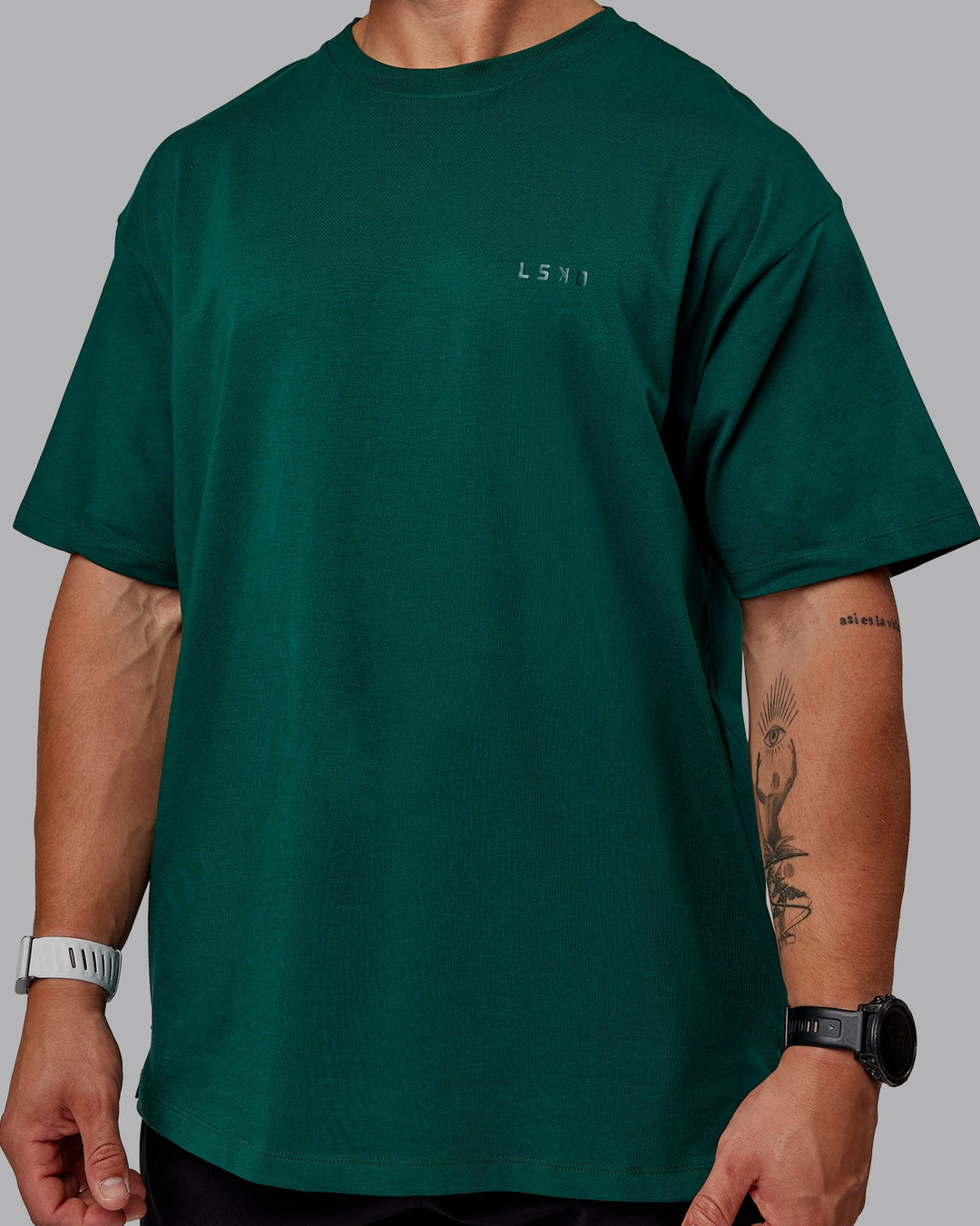 Man wearing Unisex Deluxe PimaFLX Tee Oversize - Deep Emerald