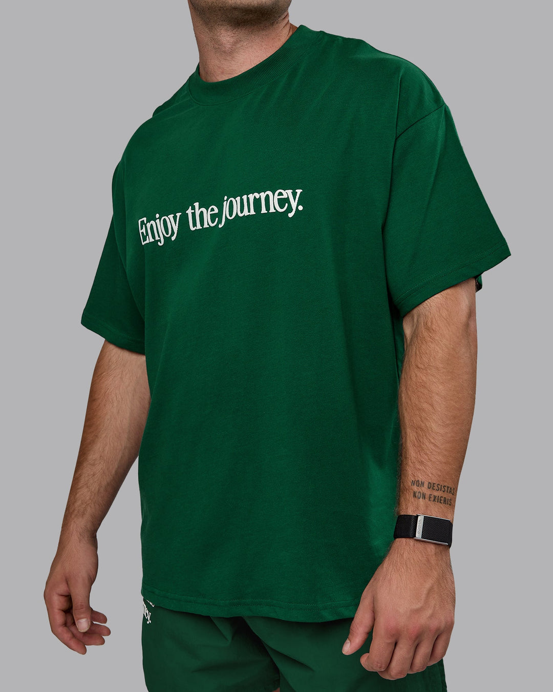 Man wearing Unisex Enjoy The Journey Heavyweight Tee Oversize - Deep Emerald-Off-White