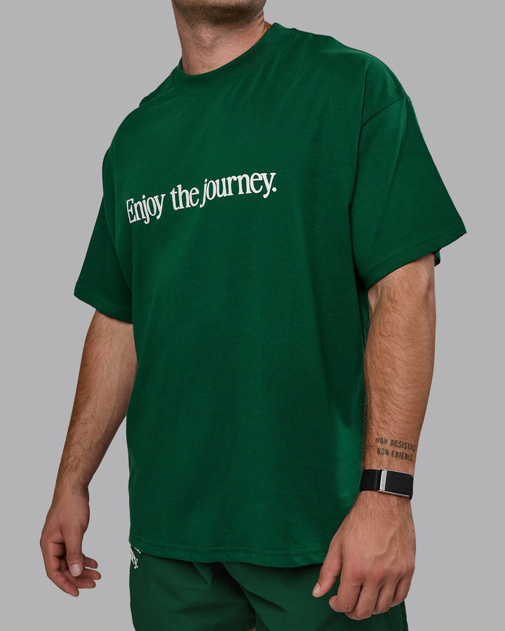 Man wearing Unisex Enjoy The Journey Heavyweight Tee Oversize - Deep Emerald-Off-White
