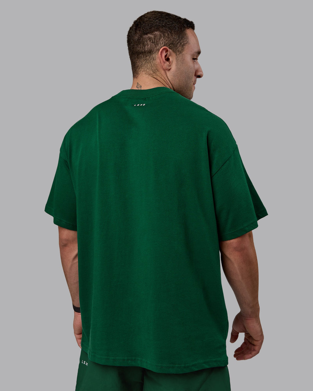 Man wearing Unisex Enjoy The Journey Heavyweight Tee Oversize - Deep Emerald-Off-White