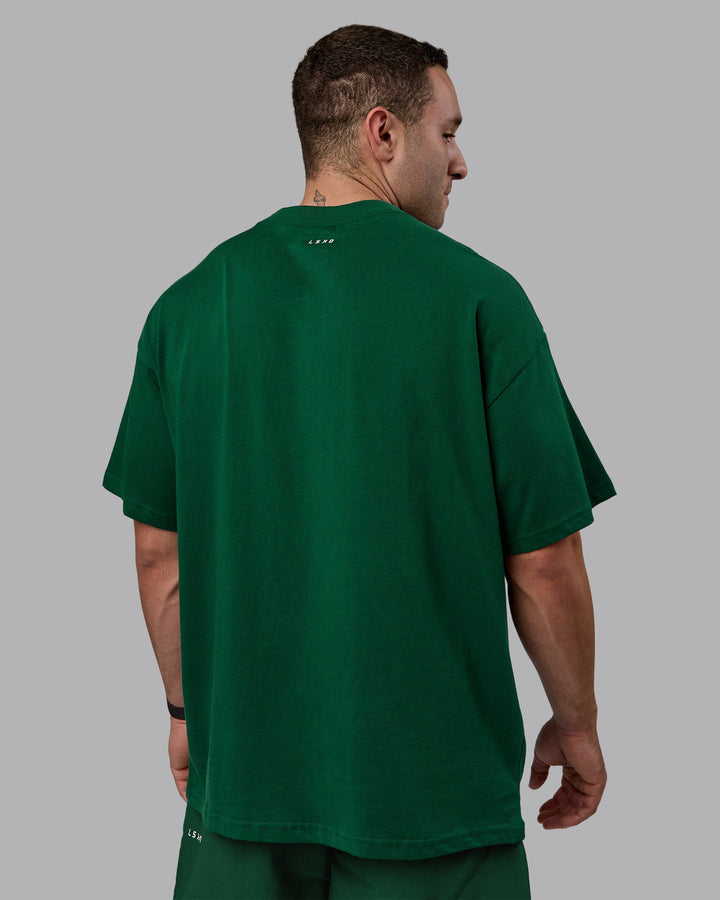 Man wearing Unisex Enjoy The Journey Heavyweight Tee Oversize - Deep Emerald-Off-White
