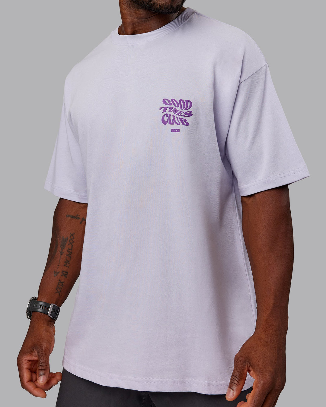 Man wearing Unisex Good Times Heavyweight Tee Oversize - Purple Heather-Purple Swirl