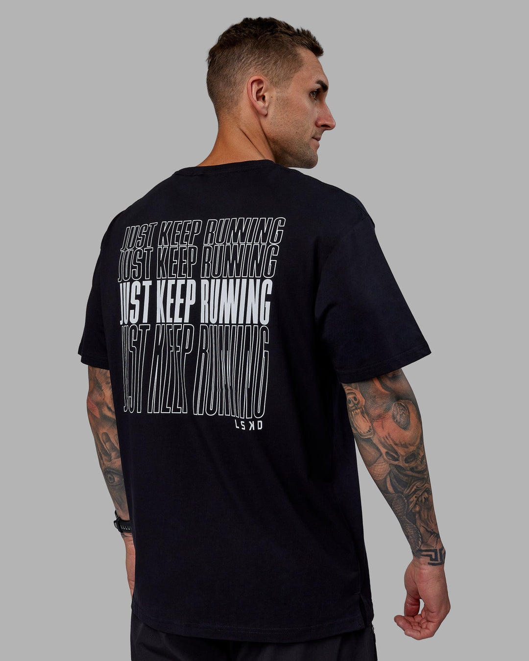 Man wearing Unisex Keep On Running FLXCotton Tee Oversize - Black-White