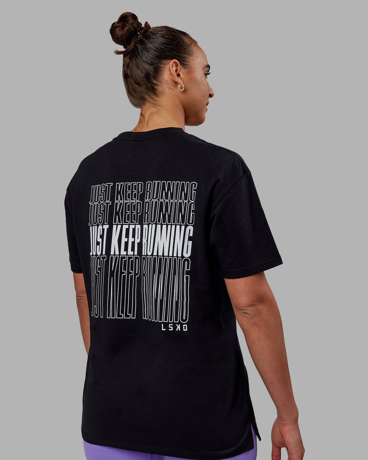 Woman wearing Unisex Keep On Running FLXCotton Tee Oversize - Black-White
