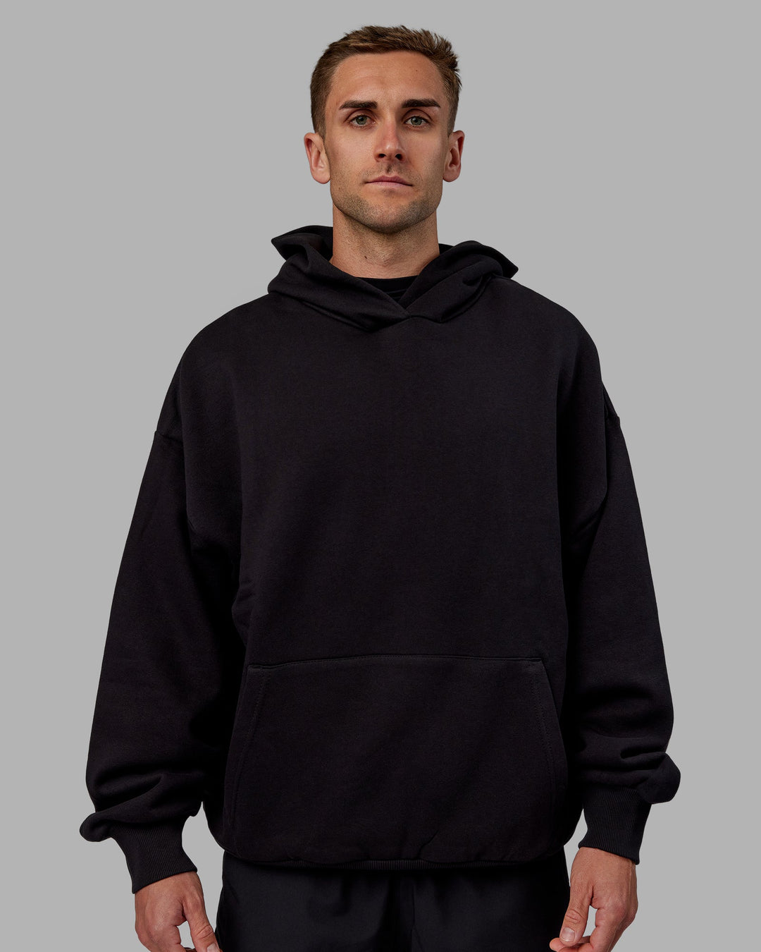 Man wearing Unisex Keep on Running Hoodie Oversize - Black-White