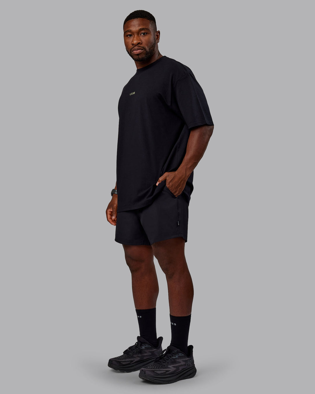 Man wearing Unisex Leg It FLXCotton Tee Oversize - Black-Volt