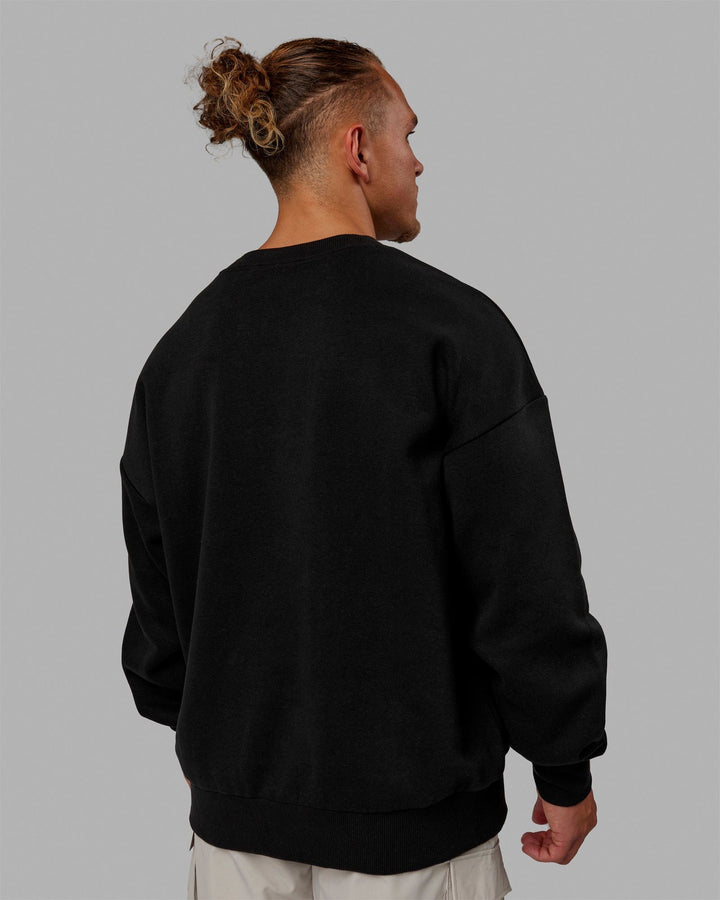 Man wearing Unisex MVP Sweater Oversize - Black