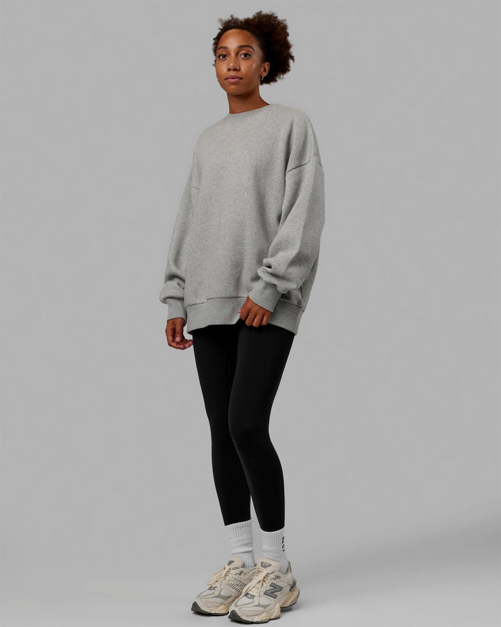 Woman wearing Unisex MVP Sweater Oversize - Light Grey Marl
