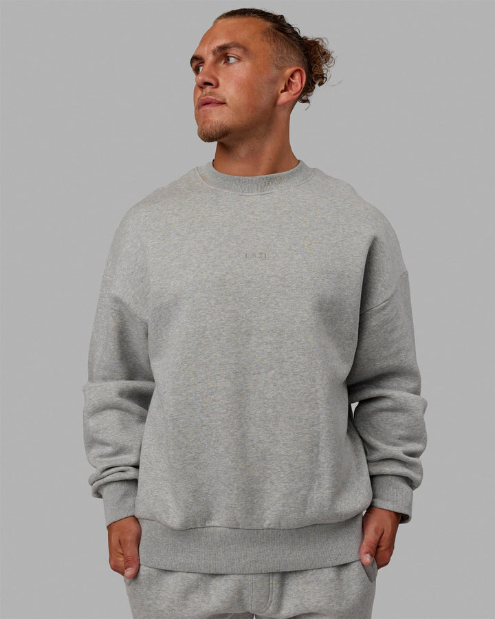 Man wearing Unisex MVP Sweater Oversize - Light Grey Marl
