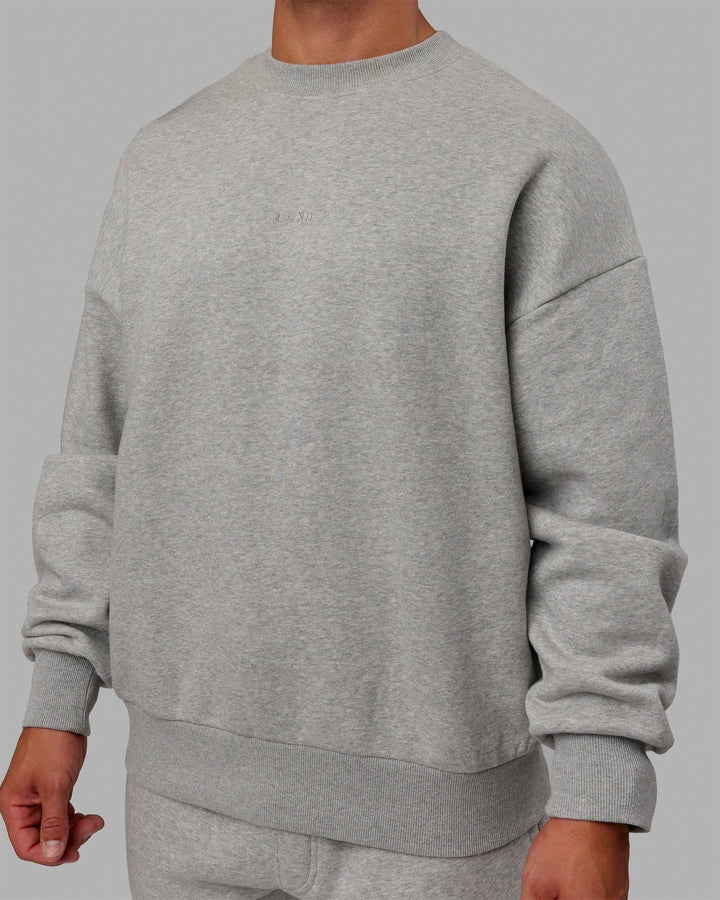 Man wearing Unisex MVP Sweater Oversize - Light Grey Marl
