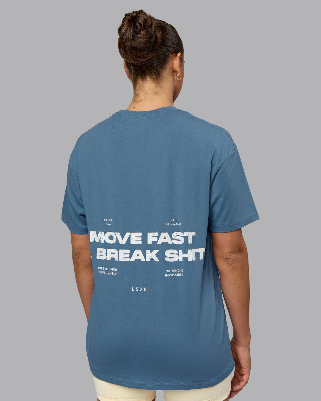 Woman wearing Unisex Move Fast Value Series FLXCotton Tee Oversize - Elemental Blue-Off White