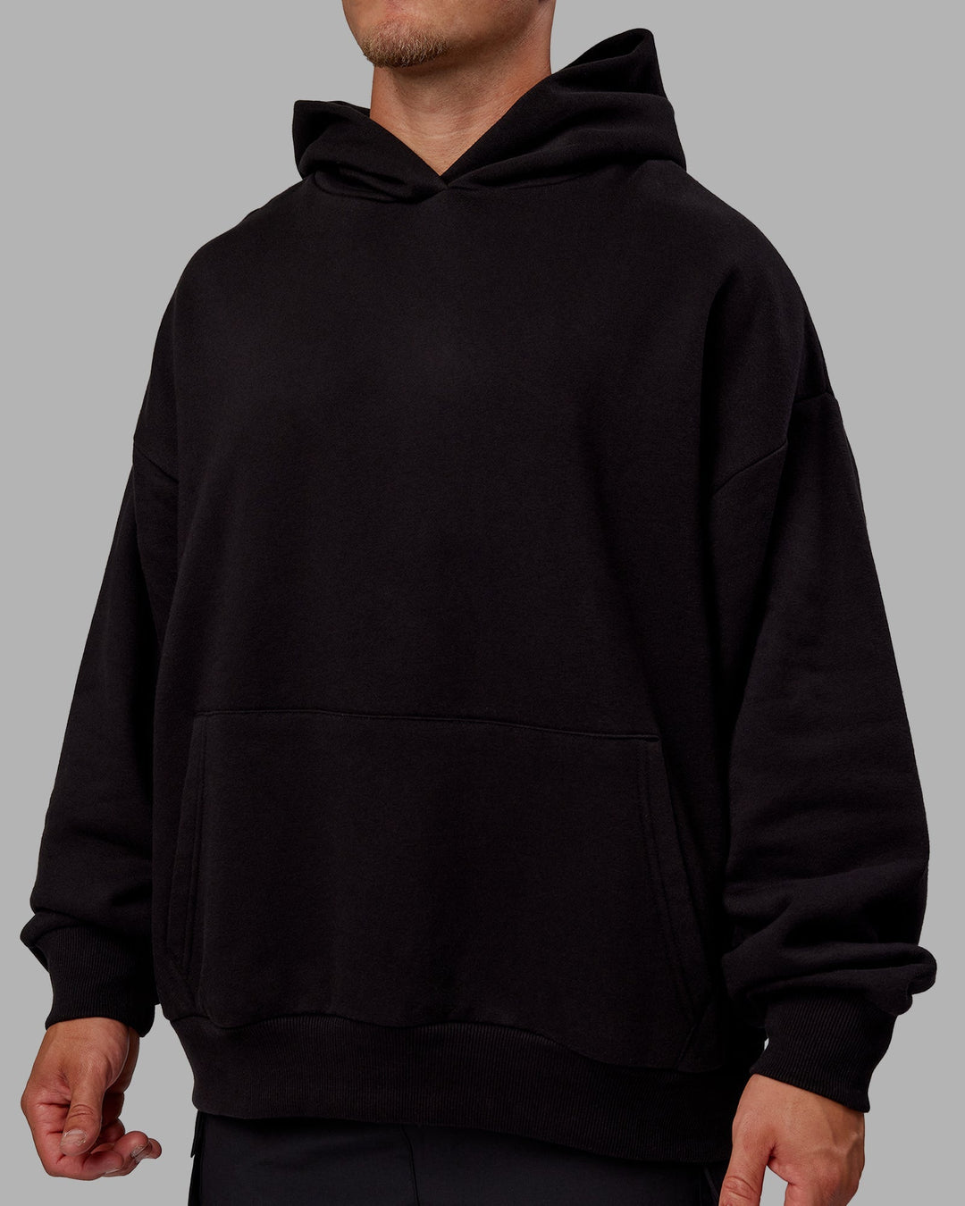 Man wearing Sara Unisex Hoodie Oversize - Black-Black