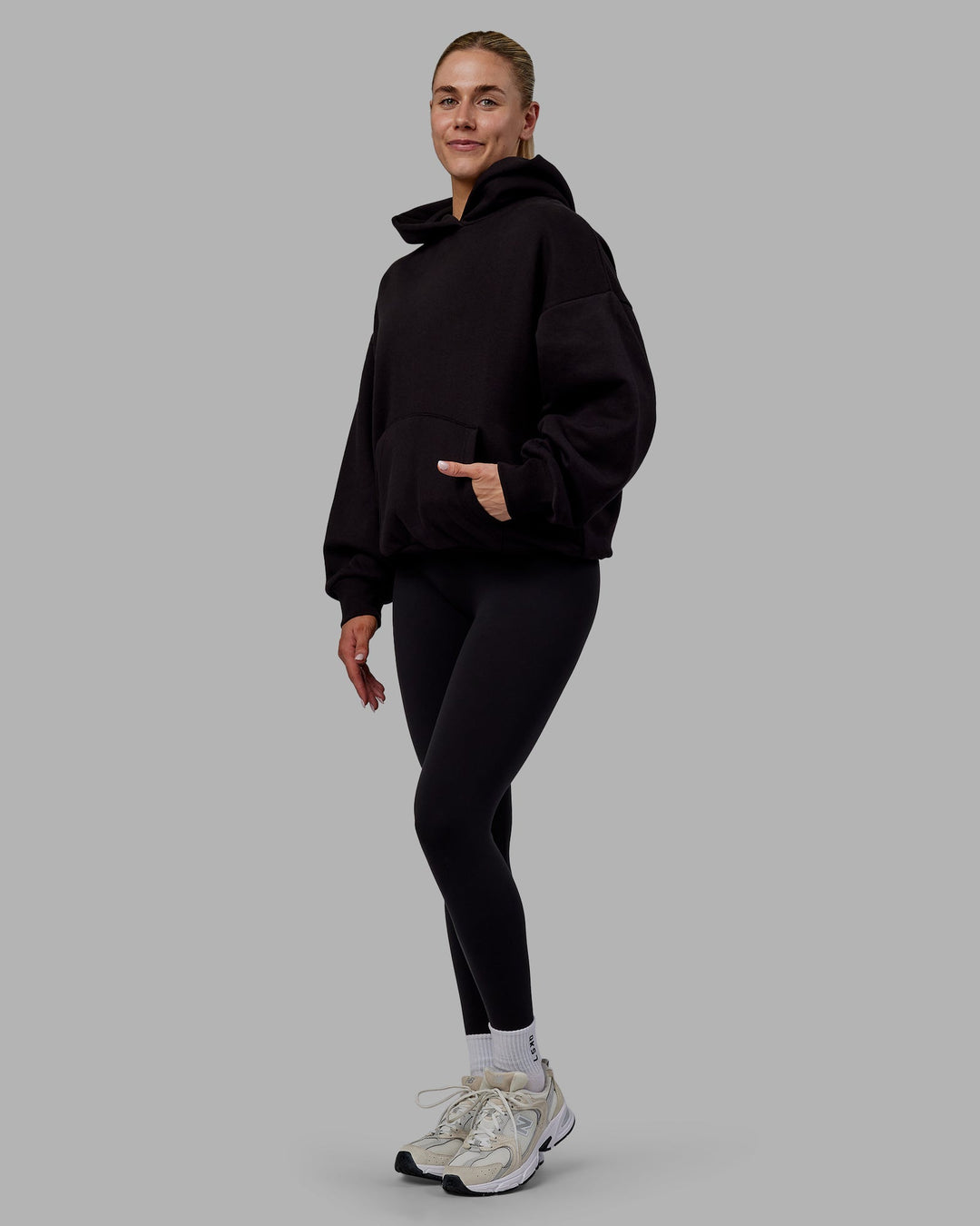 Woman wearing Sara Unisex Hoodie Oversize - Black-Black