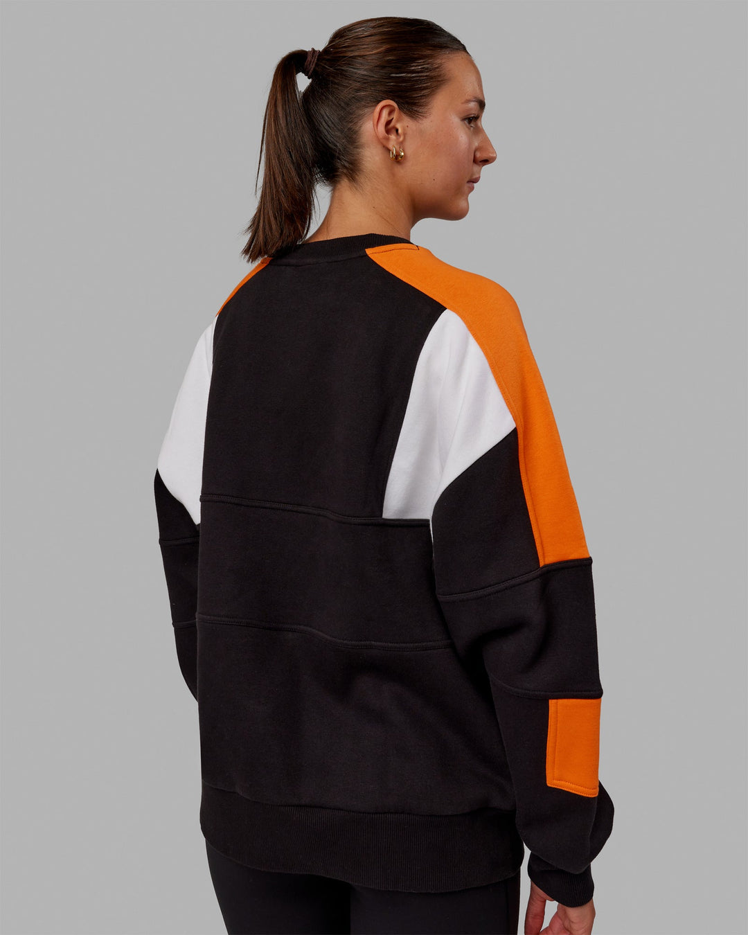 Woman wearing Unisex Slam Sweater Oversize - Black-Ultra Orange