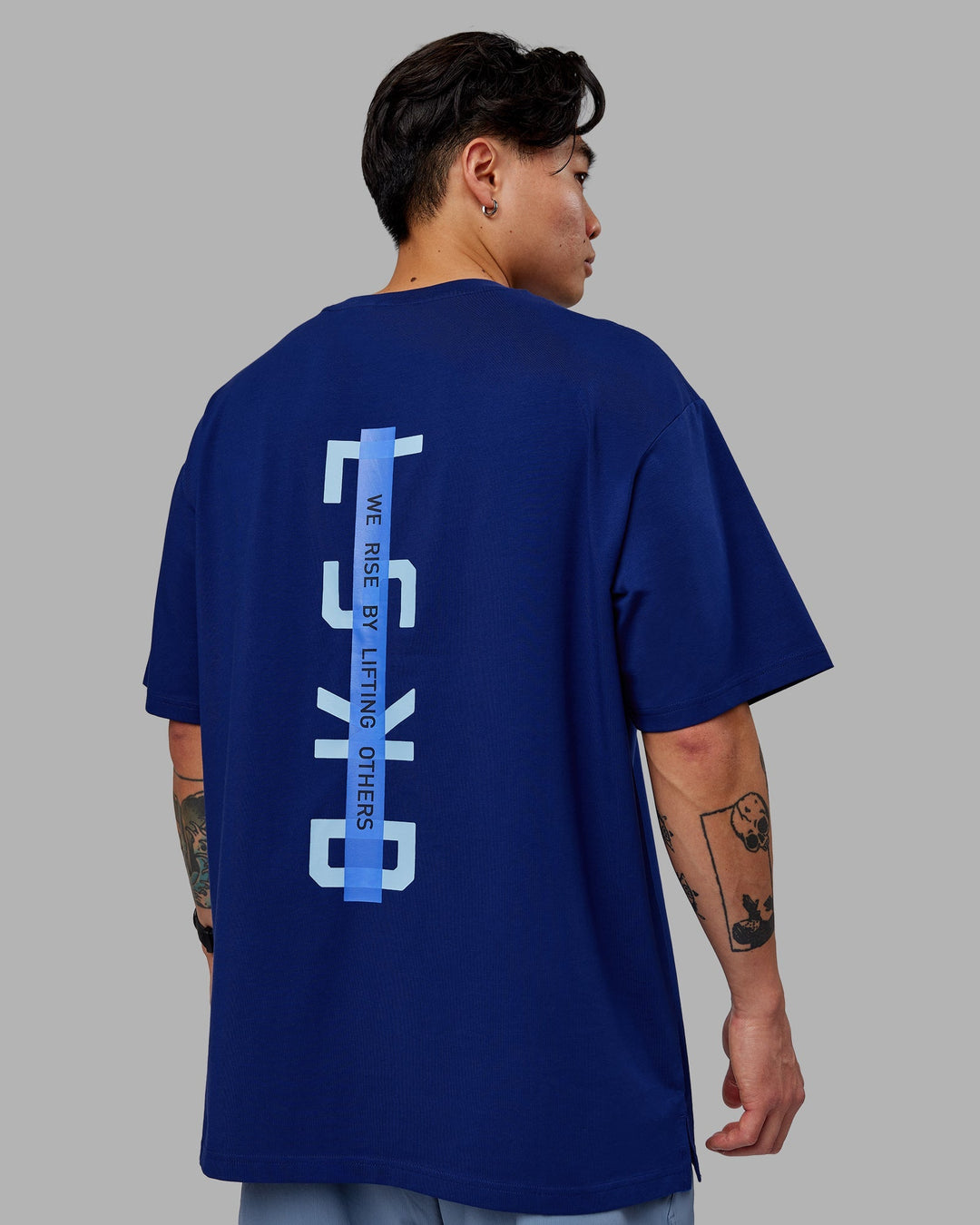 Man wearing Unisex Strike Through FLXCotton Tee Oversize - Midnight Blue-Glacial Blue