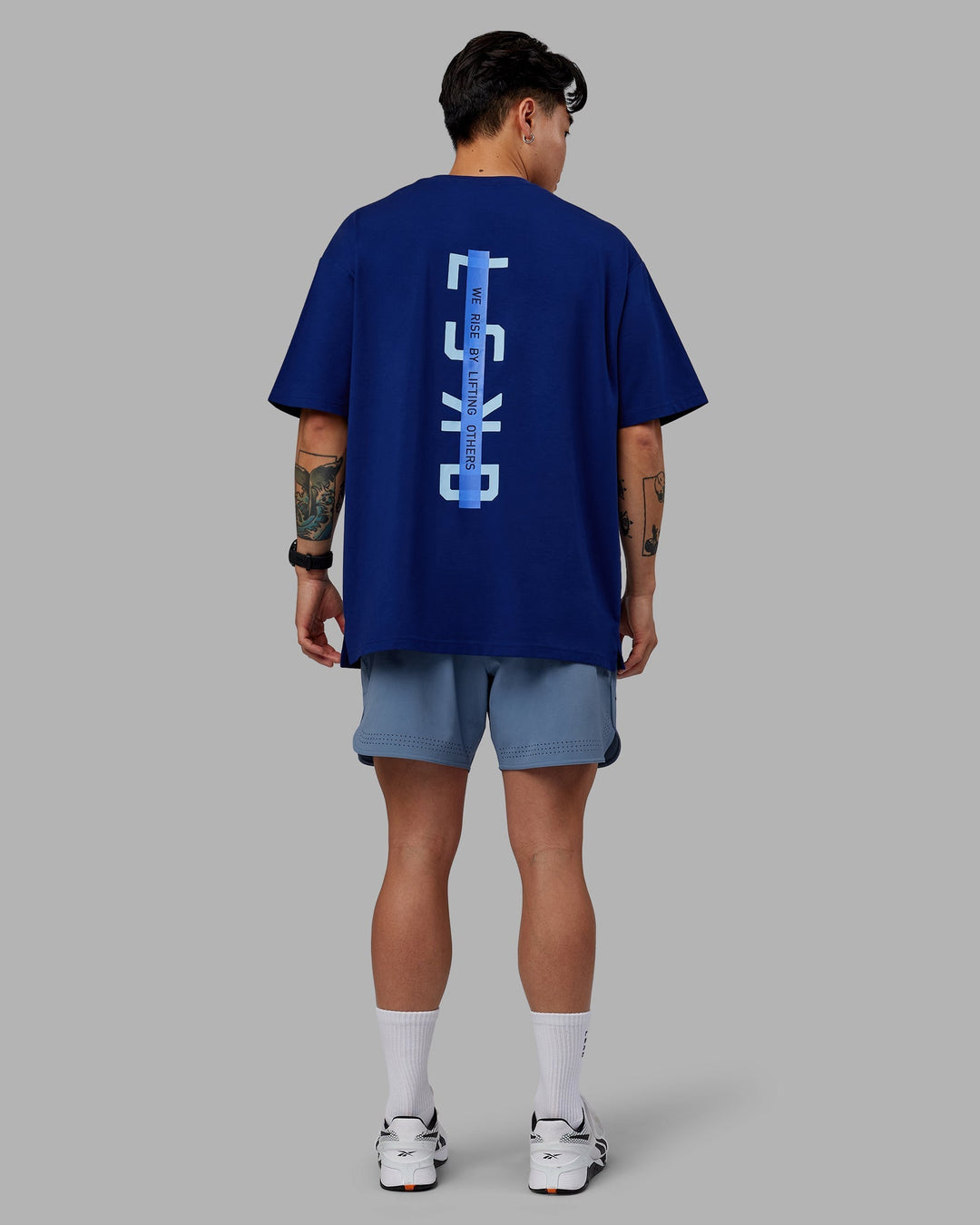 Man wearing Unisex Strike Through FLXCotton Tee Oversize - Midnight Blue-Glacial Blue