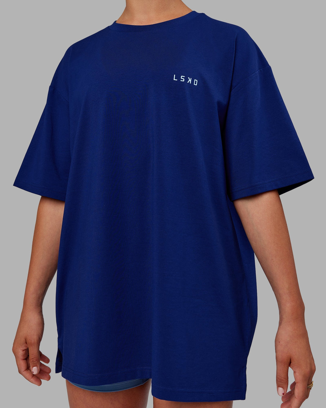 Woman wearing Unisex Strike Through FLXCotton Tee Oversize - Midnight Blue-Glacial Blue