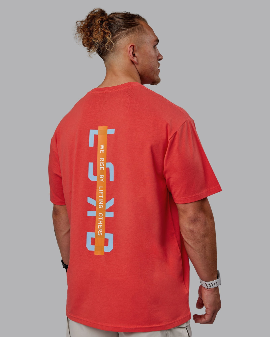 Man wearing Unisex Strike Through FLXCotton Tee Oversize - Cayenne-Glacial Blue