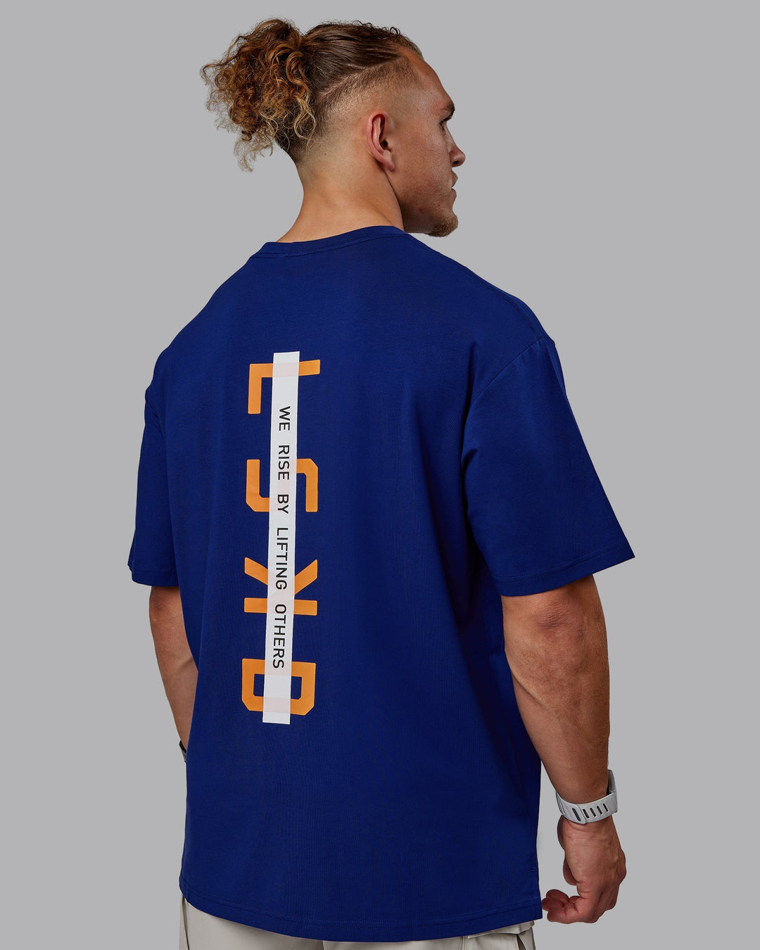 Man wearing Unisex Strike Through FLXCotton Tee Oversize - Midnight Blue-Vibrant Orange