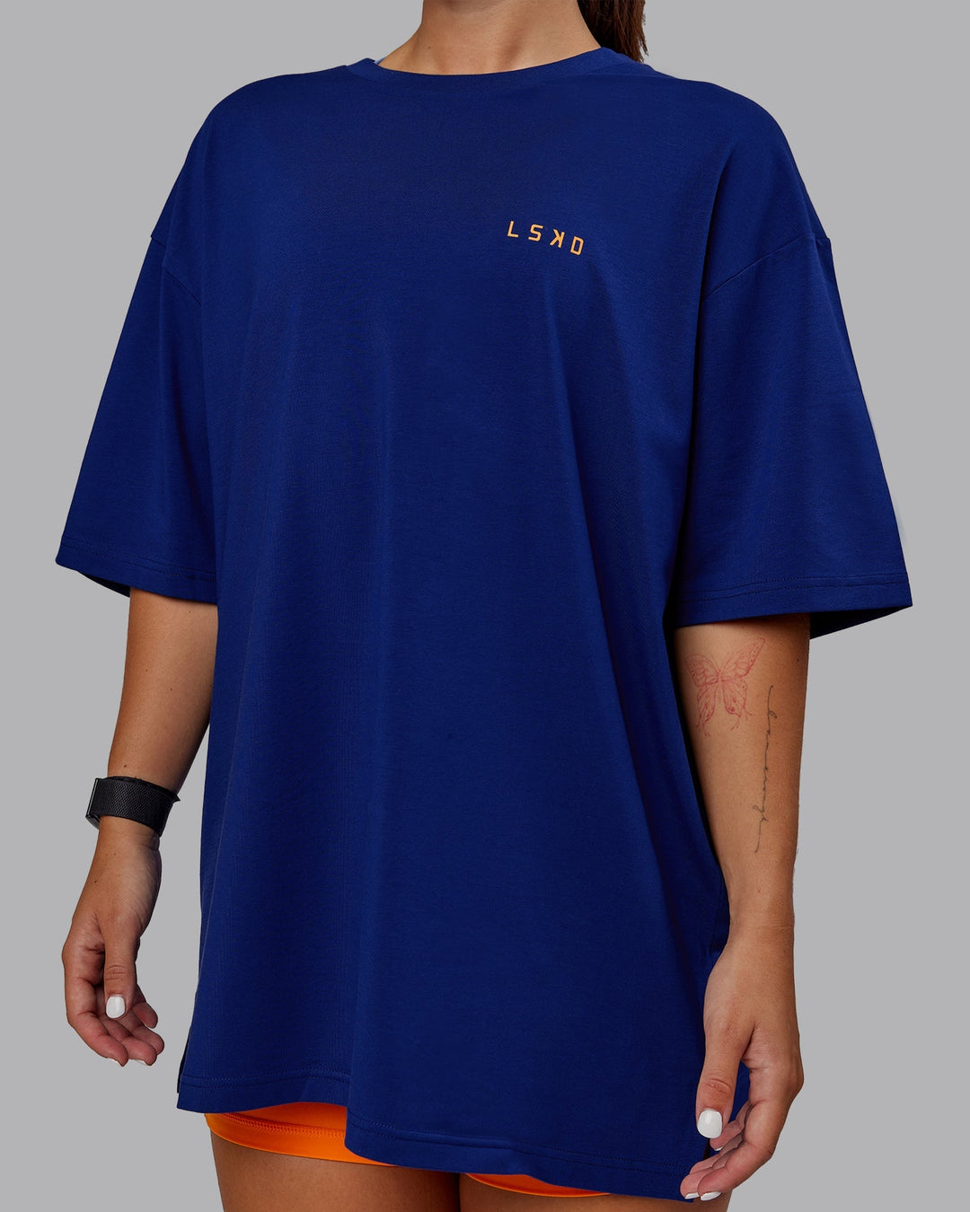 Woman wearing Unisex Strike Through FLXCotton Tee Oversize - Midnight Blue-Vibrant Orange