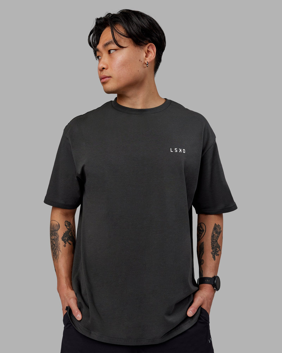 Man wearing Unisex Strike Through FLXCotton Tee Oversize - Pirate Black-Black