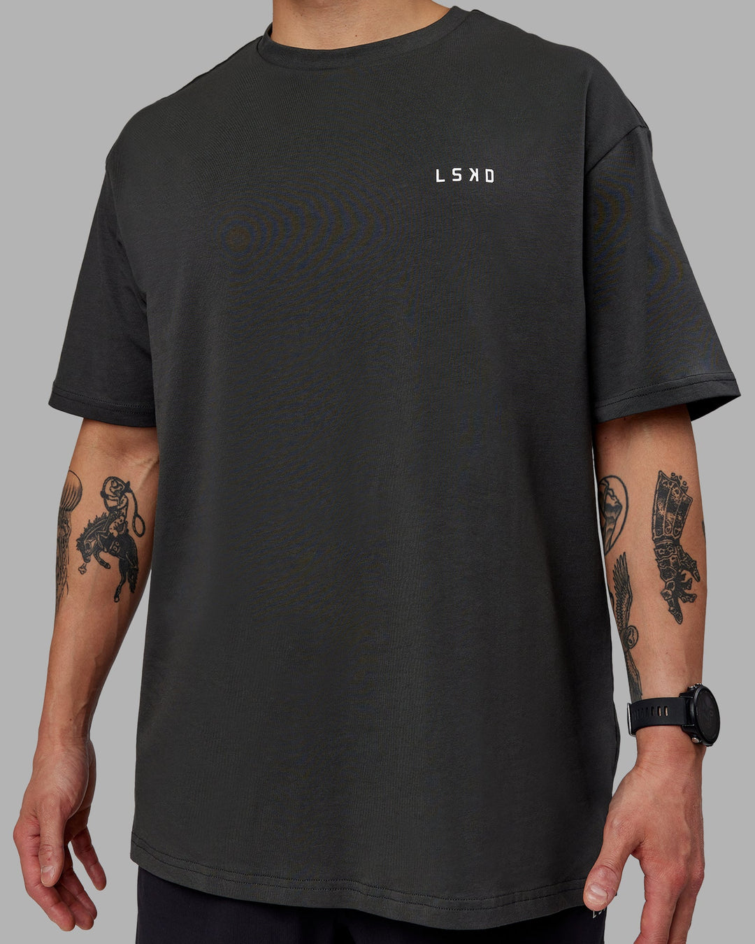 Man wearing Unisex Strike Through FLXCotton Tee Oversize - Pirate Black-Black