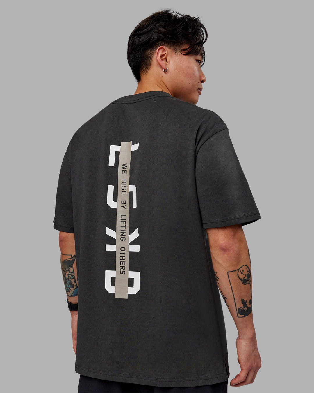 Man wearing Unisex Strike Through FLXCotton Tee Oversize - Pirate Black-Black