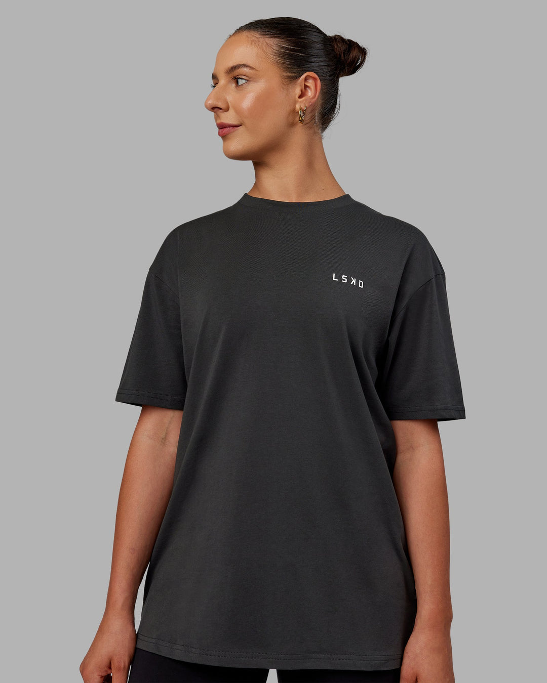 Woman wearing Unisex Strike Through FLXCotton Tee Oversize - Pirate Black-Black