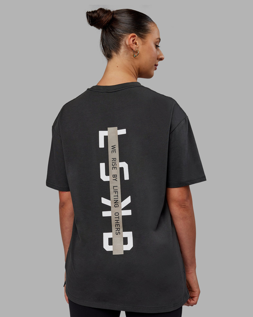 Woman wearing Unisex Strike Through FLXCotton Tee Oversize - Pirate Black-Black