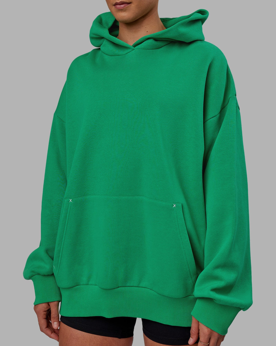 Woman wearing Unisex We Rise Hoodie Oversize - Impact Green-White