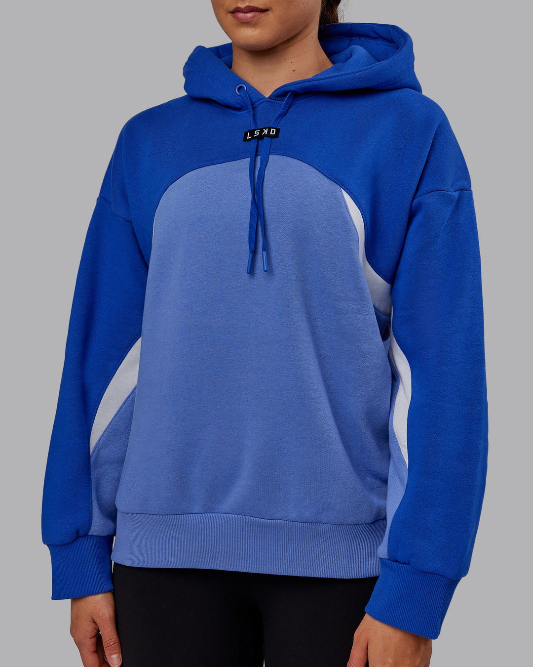 Woman wearing Unisex Y2K Concept Panel Hoodie - Power Cobalt-White