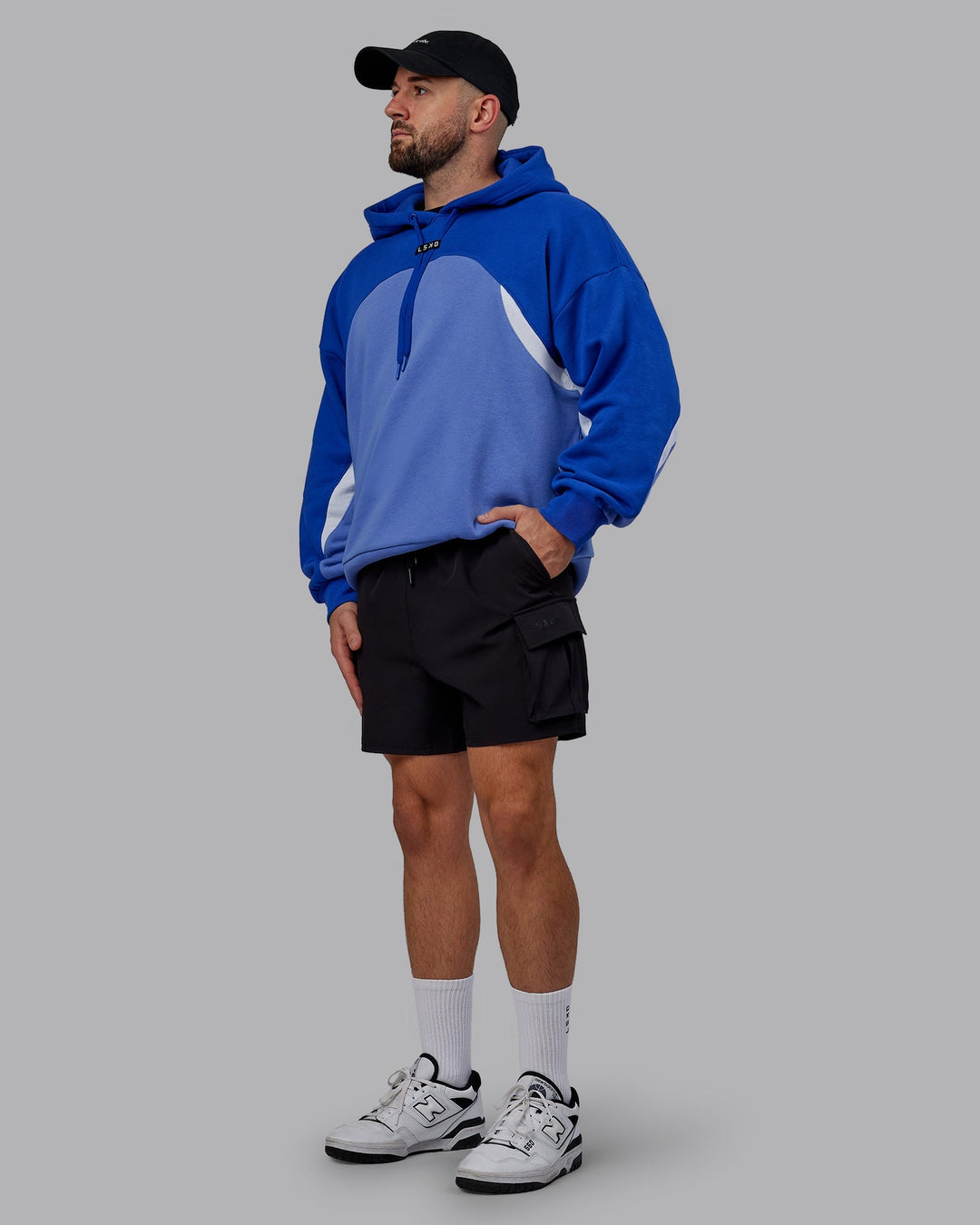 Man wearing Unisex Y2K Concept Panel Hoodie - Power Cobalt-White