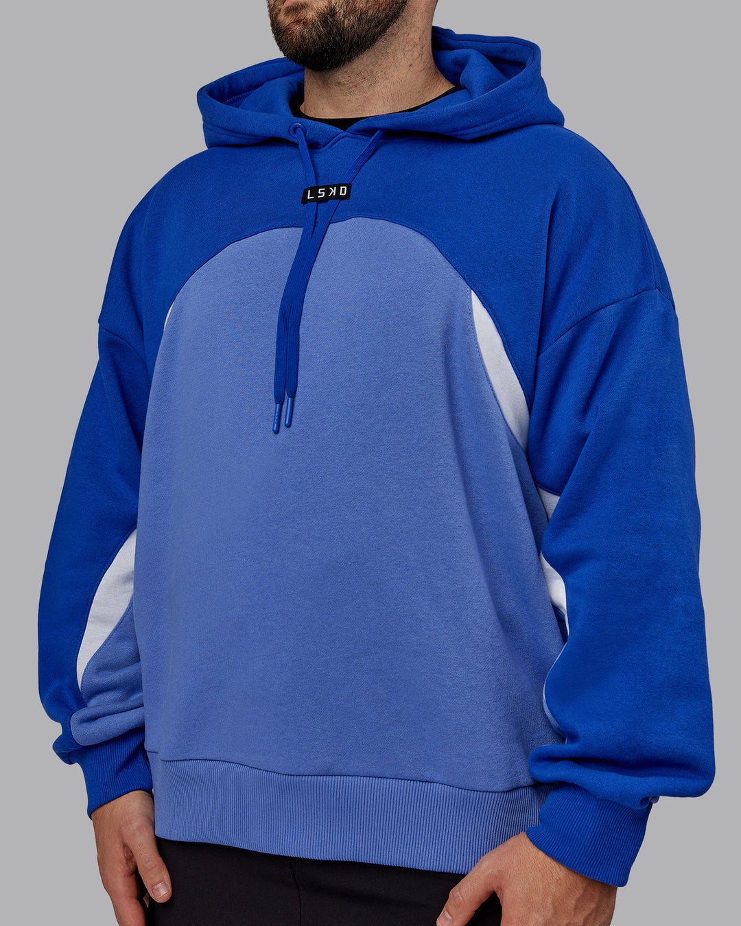 Man wearing Unisex Y2K Concept Panel Hoodie - Power Cobalt-White