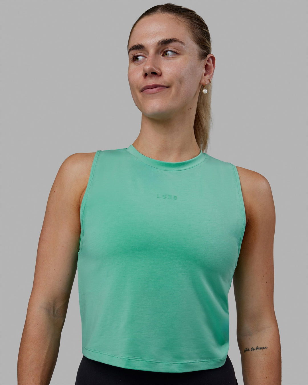 Woman wearing Vital Cropped Training Tank - Cockatoo