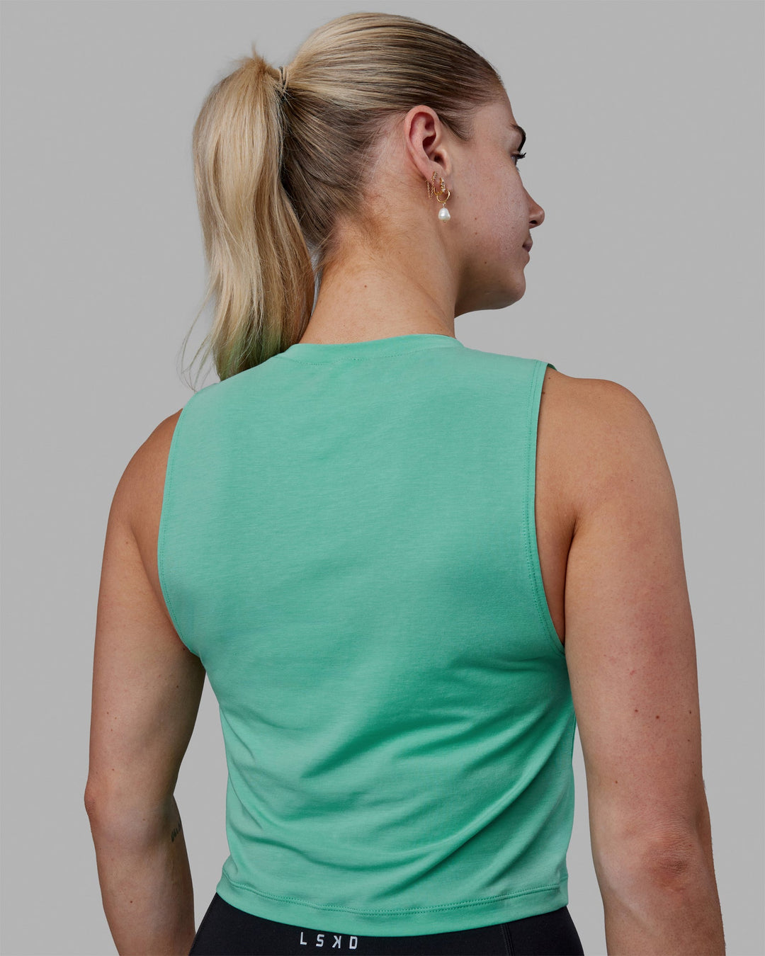 Woman wearing Vital Cropped Training Tank - Cockatoo