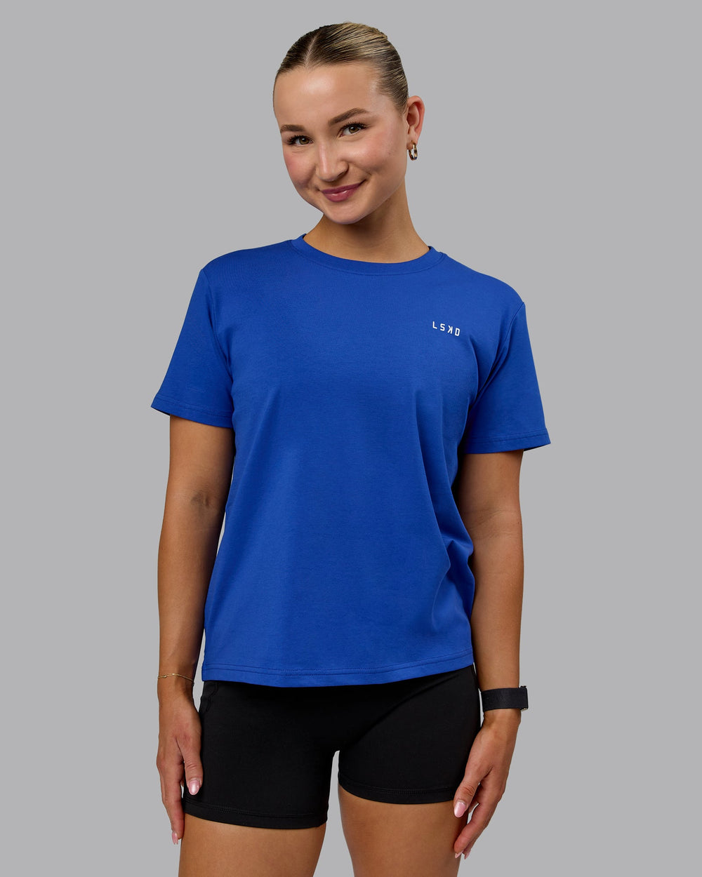 Woman wearing 1% Better Value Series FLXCotton Tee - Power Cobalt-White