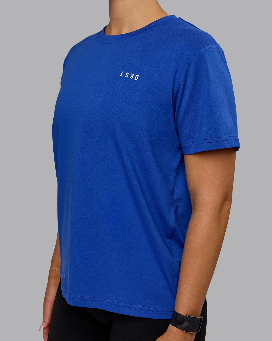 Woman wearing 1% Better Value Series FLXCotton Tee - Power Cobalt-White