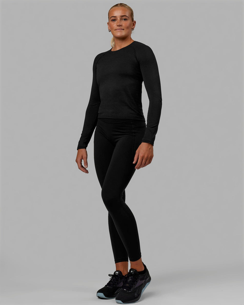 Woman wearing AeroFLX+ Seamless Long Sleeve Tee - Black Marl