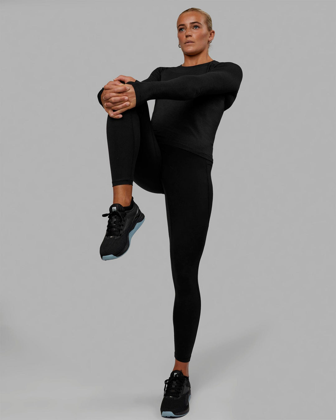 Woman wearing AeroFLX+ Seamless Long Sleeve Tee - Black Marl