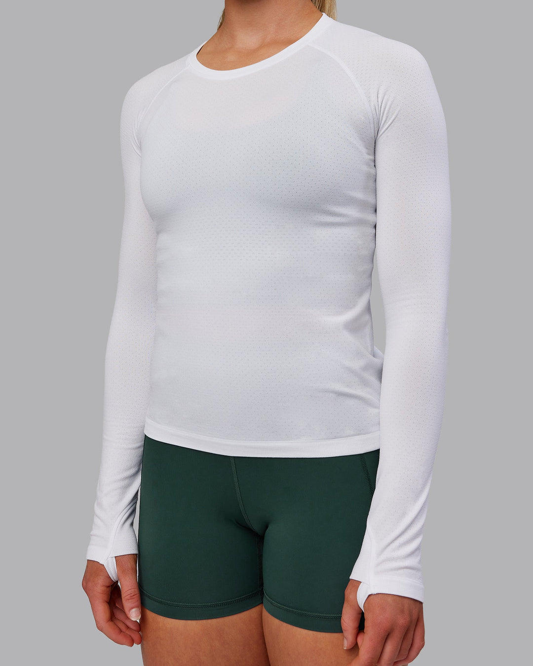 Woman wearing AeroFLX+ Seamless Long Sleeve Tee - White/White