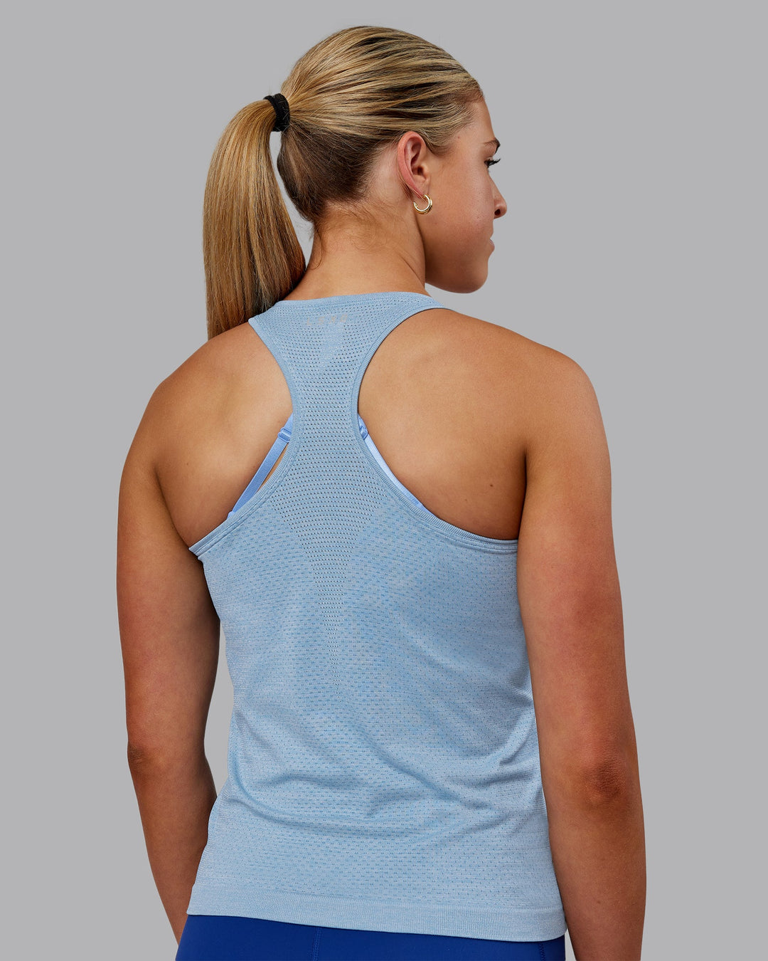 Woman wearing AeroFLX+ Seamless Tank - Elemental Blue/Ice Blue