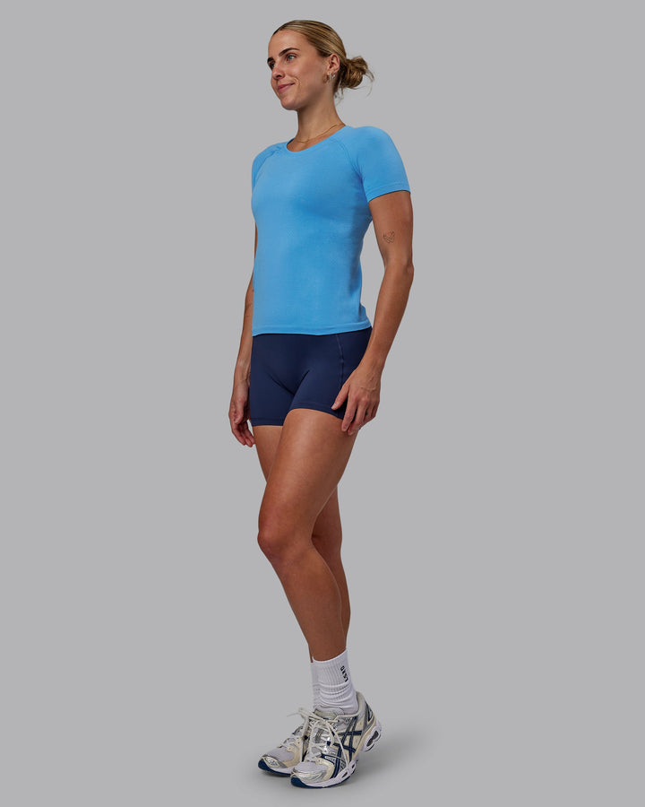 Woman wearing AeroFLX+ Seamless Tee - Azure Blue
