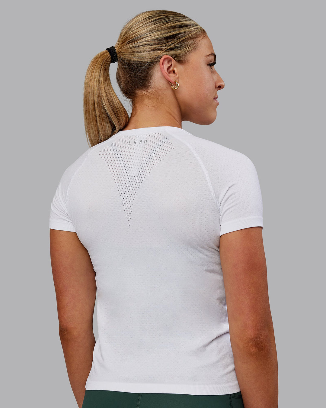 Woman wearing AeroFLX+ Seamless Tee - White/White