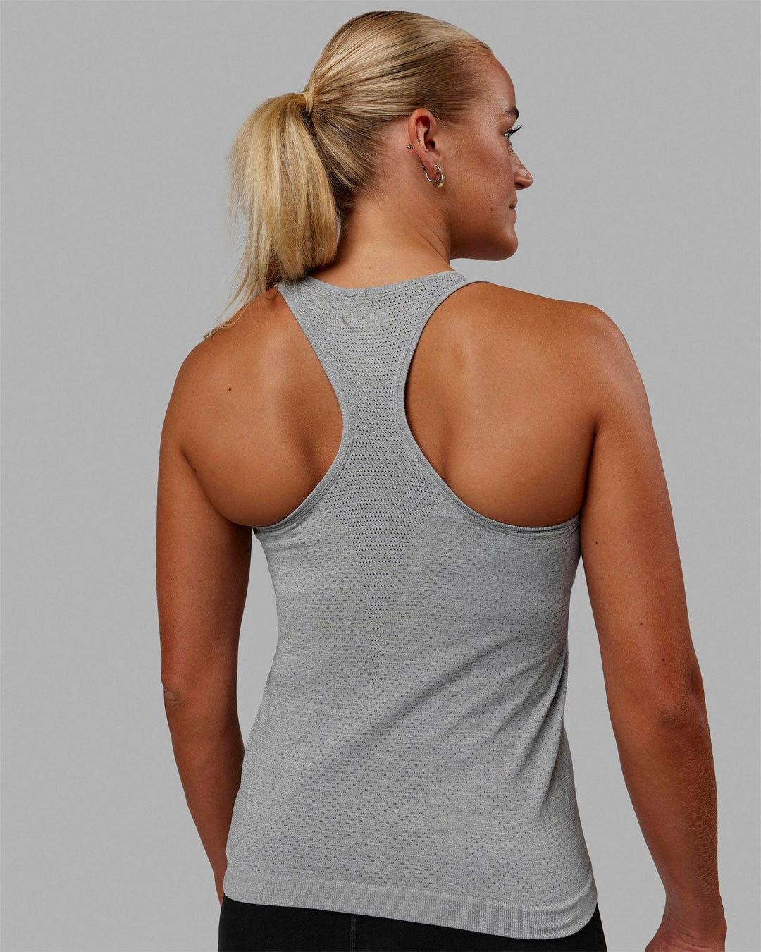 Woman wearing AeroFLX+ Seamless Tank - Light Grey Marl