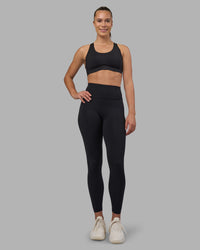 Woman wearing Stability Sports Bra - Black | Model:Charlize | Size:S (A-C Cup)
